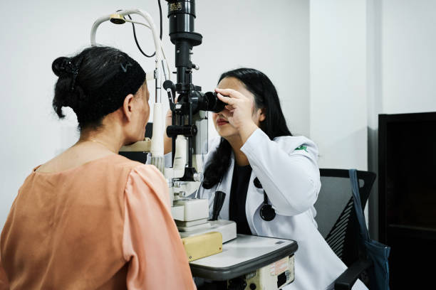 Low angle view of optometrist giving eye exam to mature woman patient in clinic Near Me Eye Specialist Aizawl